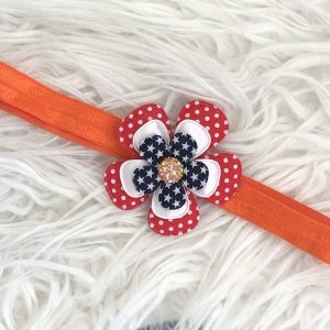 Haarband oranje met rode polkadot, witte en rode (sterretjes) bloem en oranje glinstersteentje